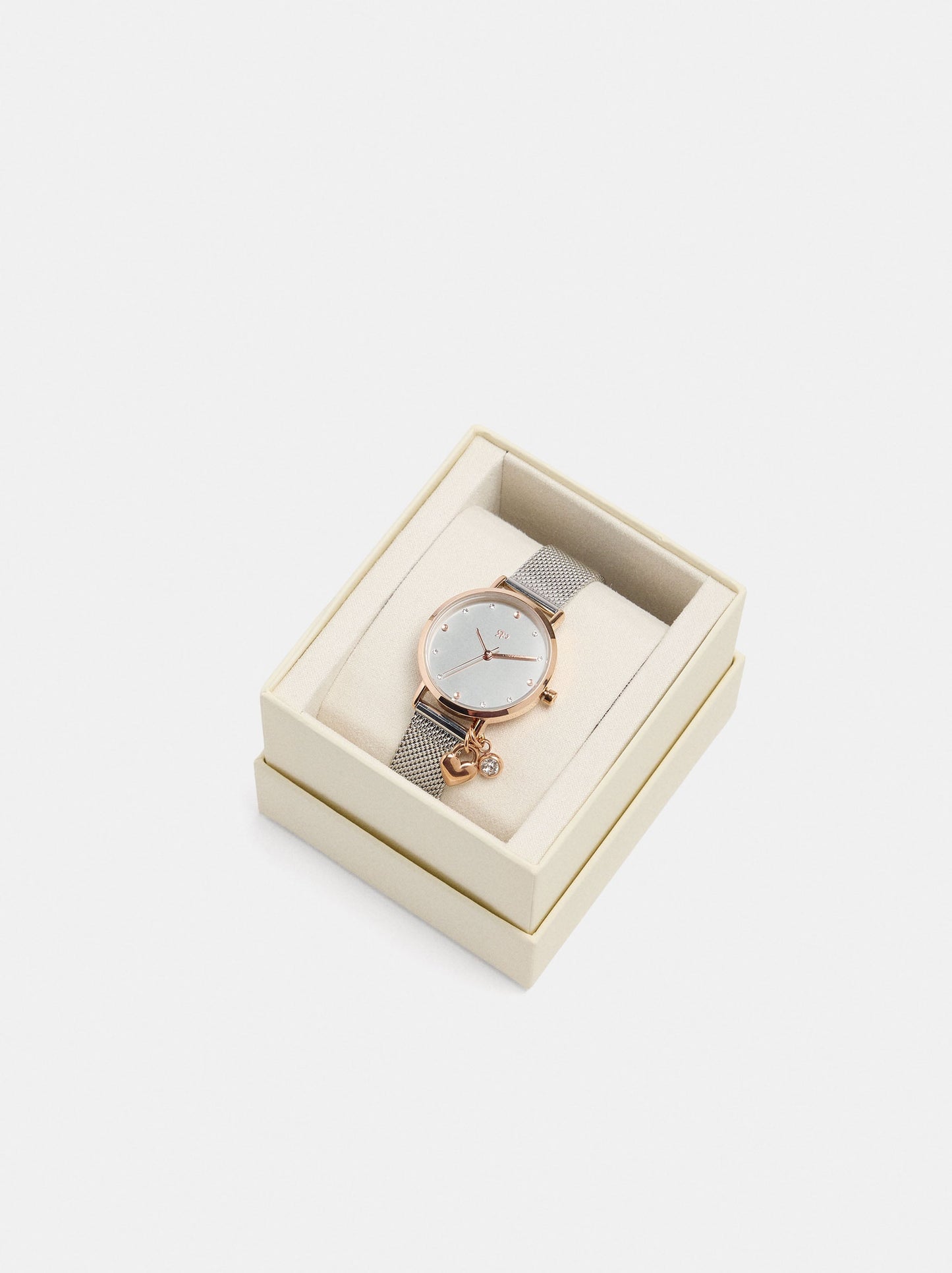 Round Watch With A Steel Mesh Strap And Charm